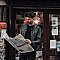 focused man reading newspaper on street