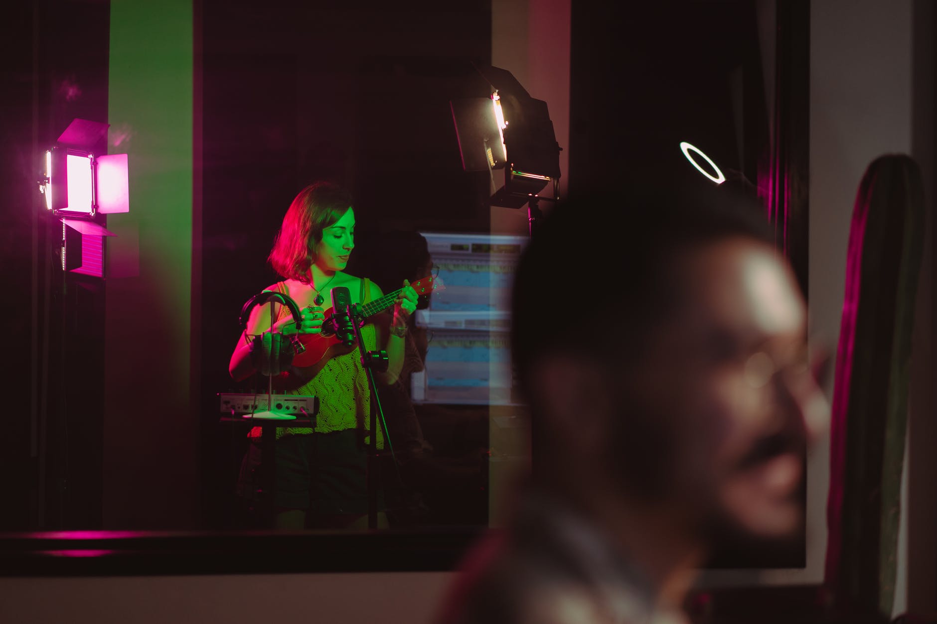 a woman using a ukulele in a audio recording